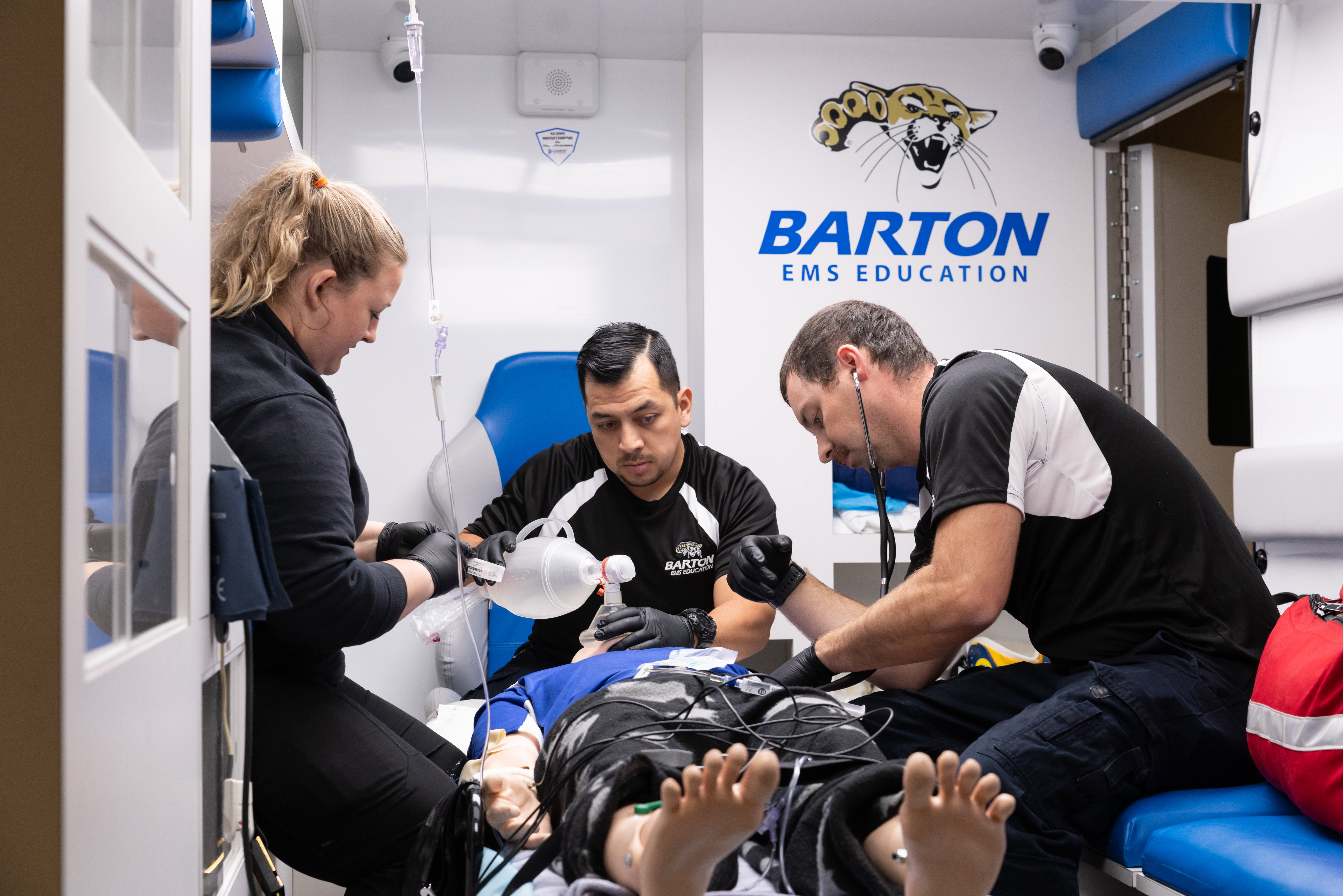 Barton students explore hands-on training with the ambulance simulator.