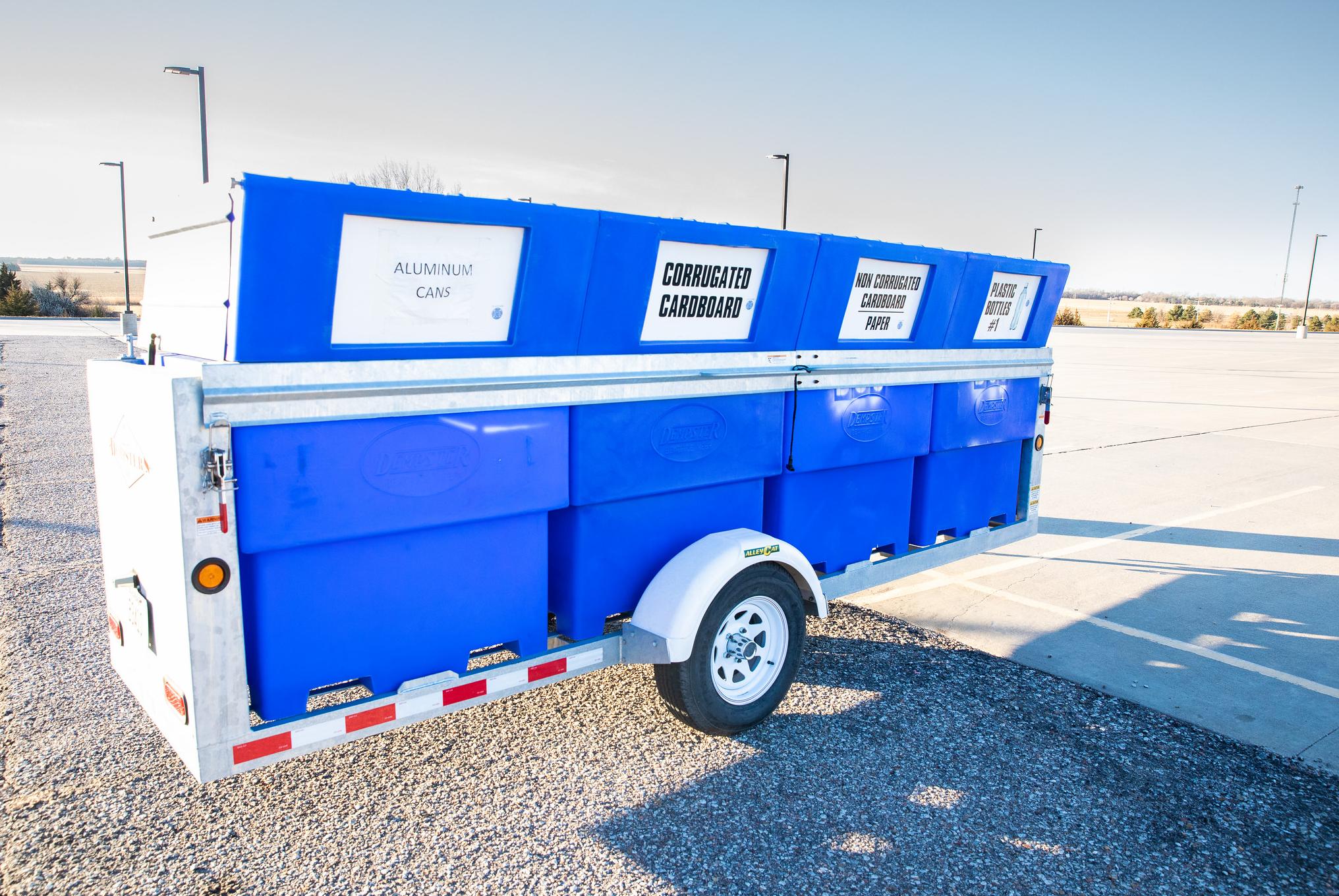blue trailer with 4 bins in it