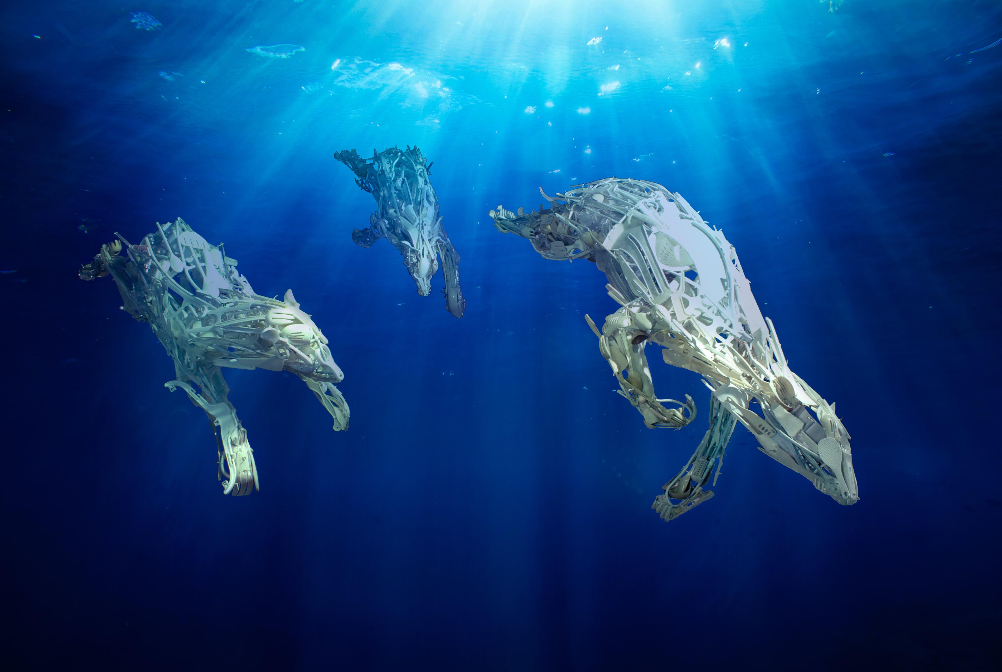 polar bears crafted out of reclaimed plastic in blue water installation