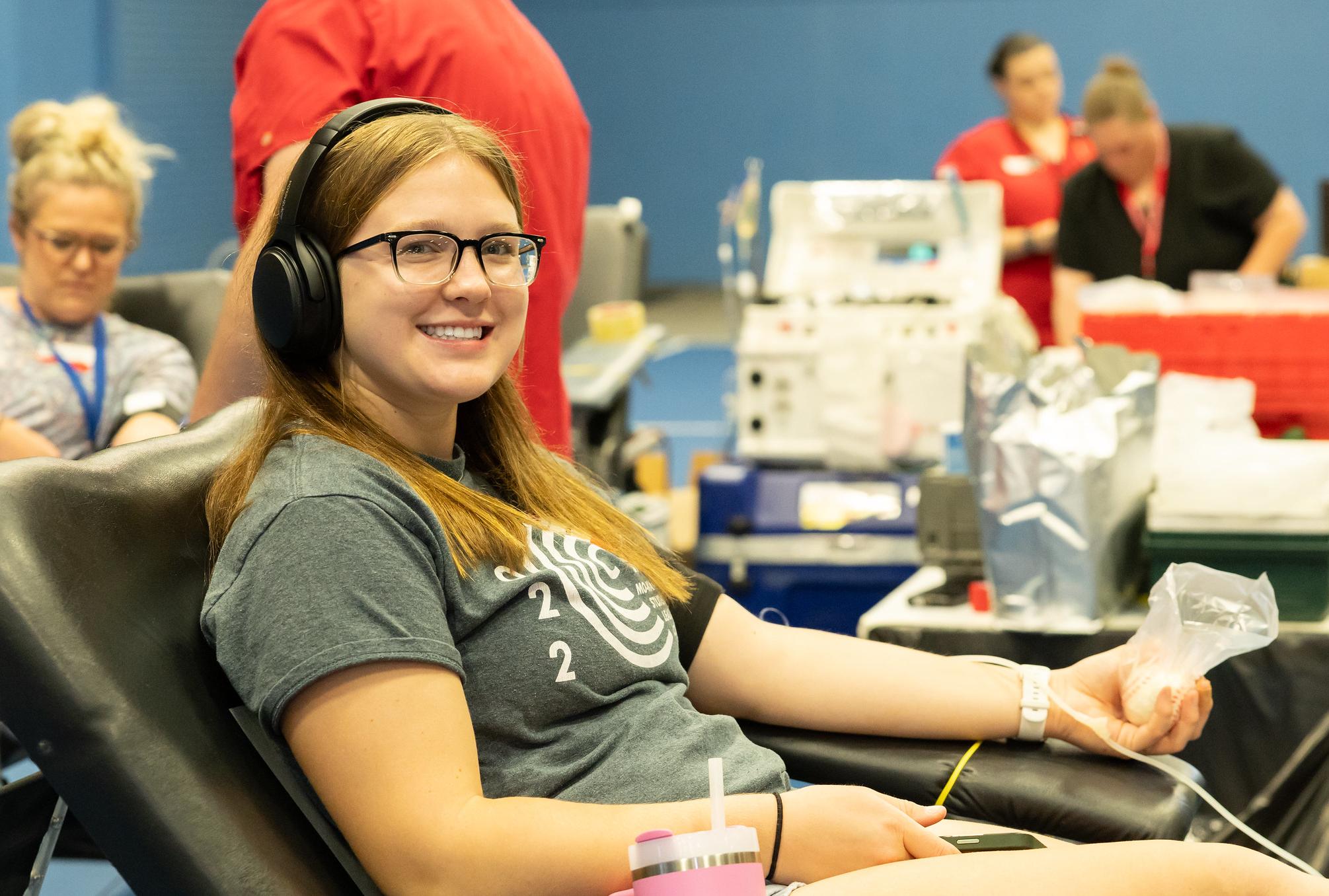 smiling woman donating blood