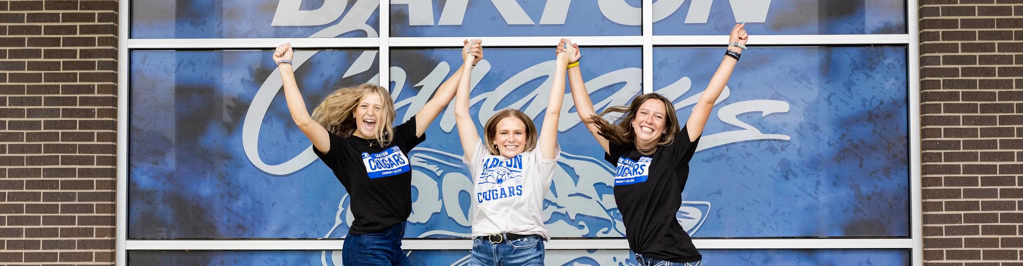 Student ambassadors jump in front of Barton Cougars window