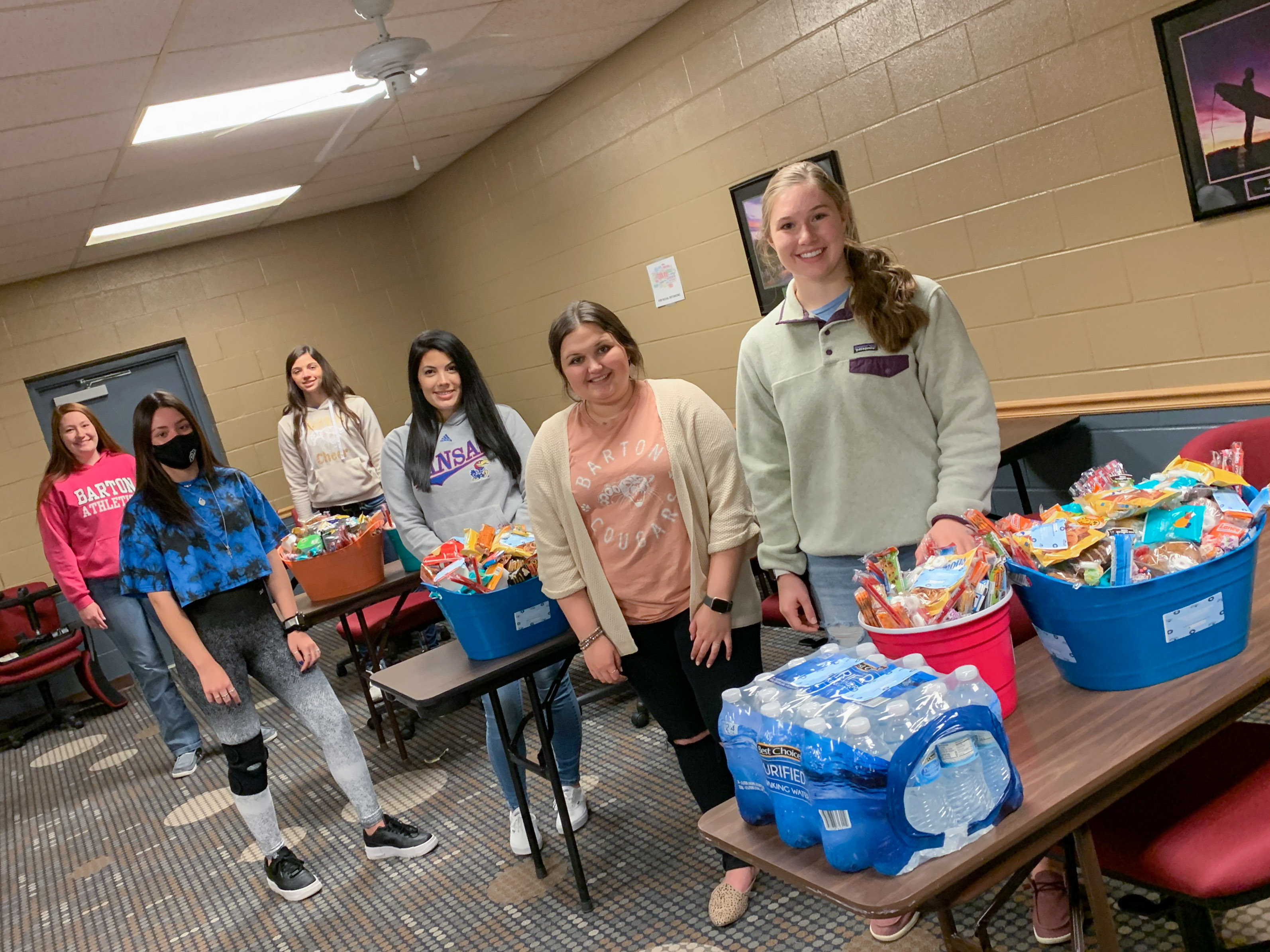 goodie baskets with students standing by them