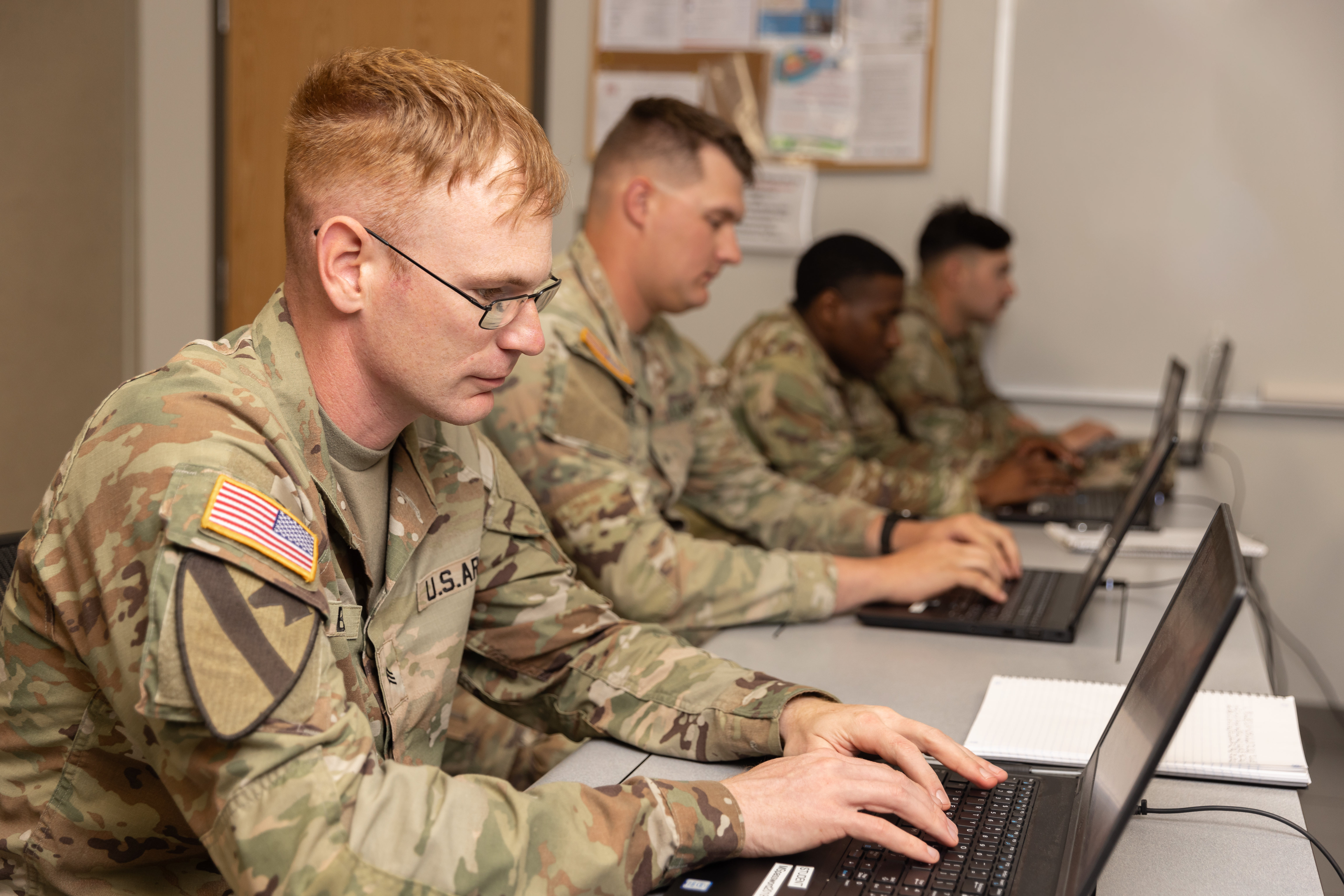 Soldiers studying during a college class.