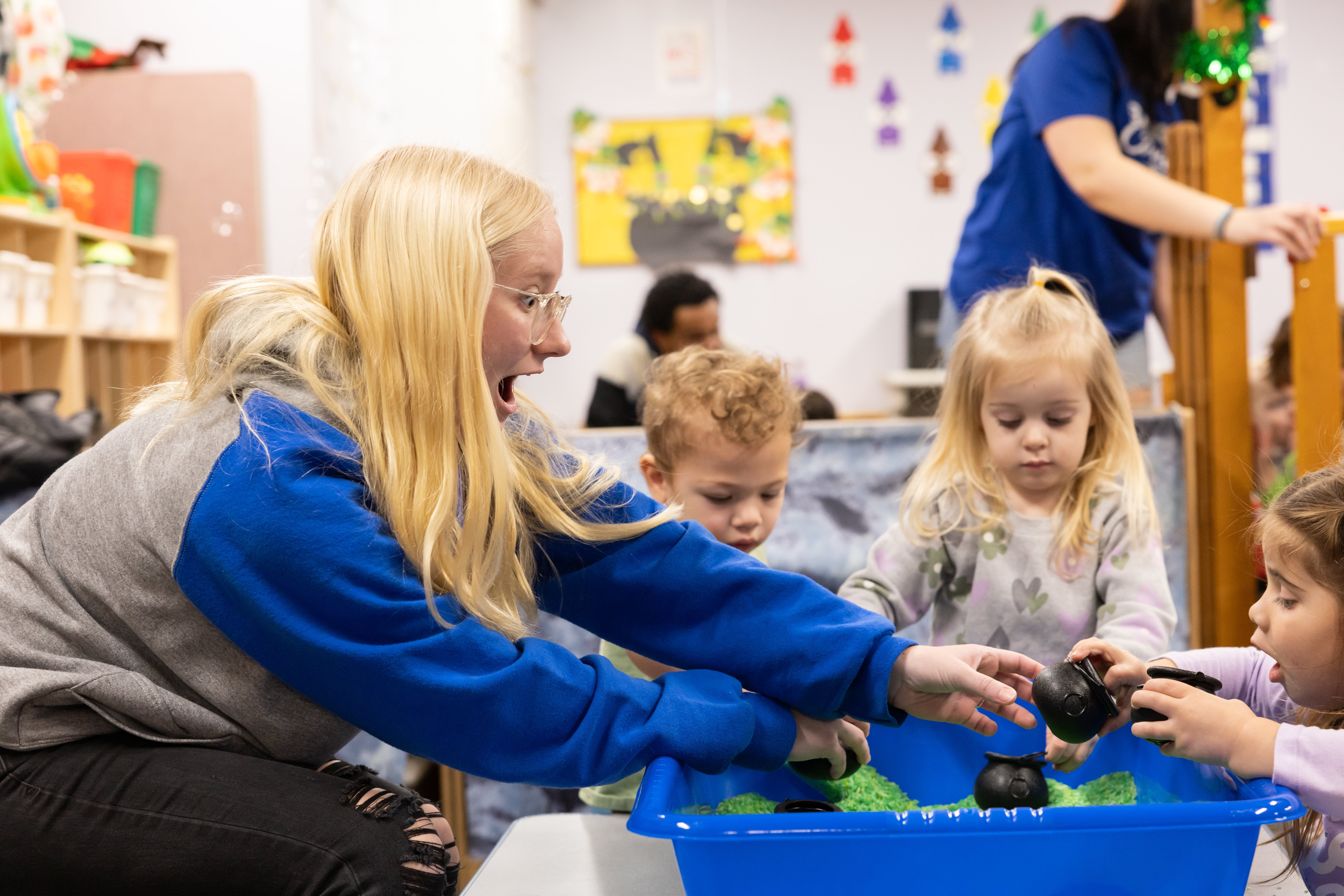 A Barton student guides young children through a hands-on activity. 