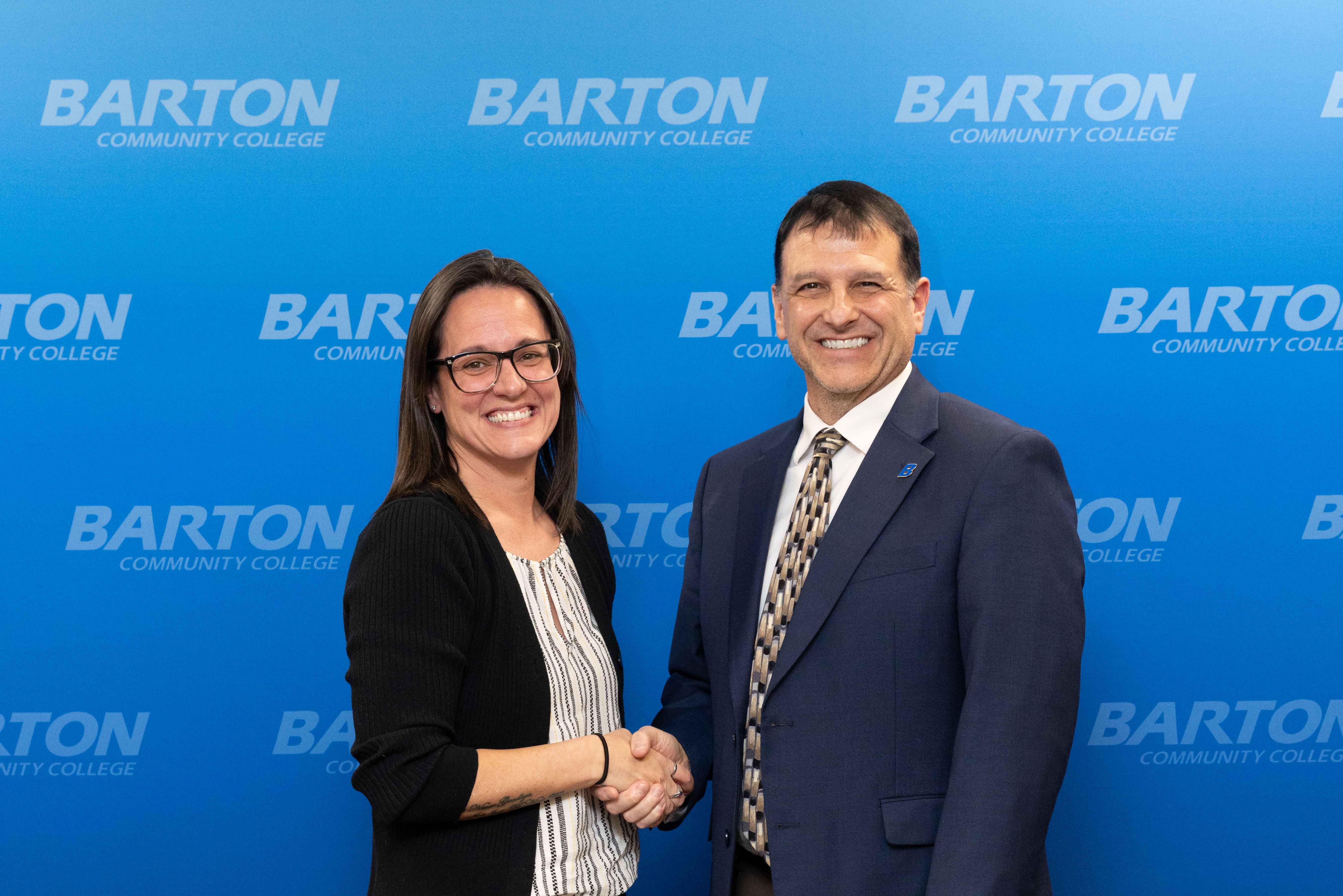 woman shaking man's hand