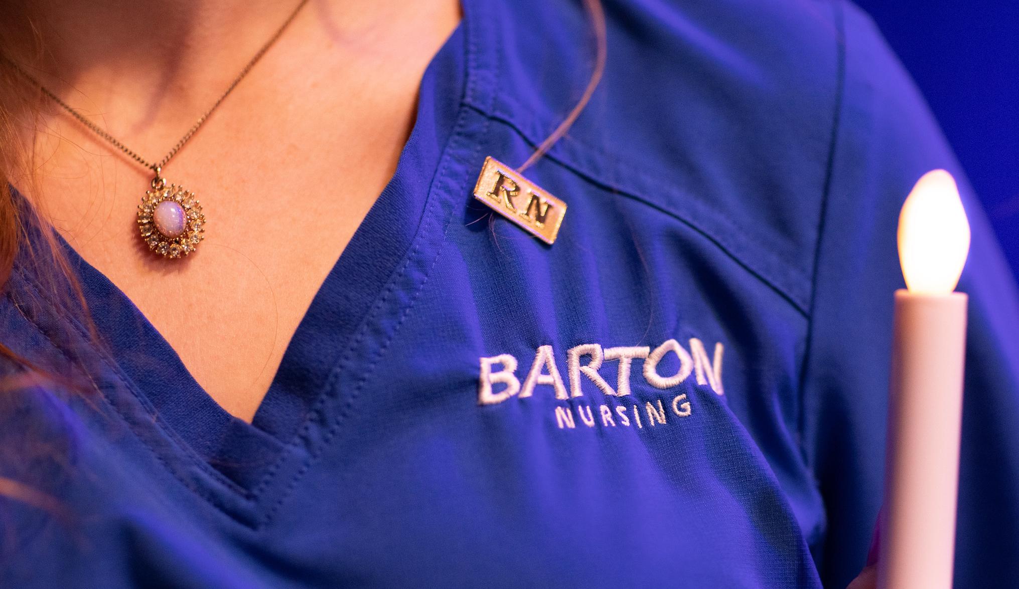 close up of barton nursing uniform and candle and pin