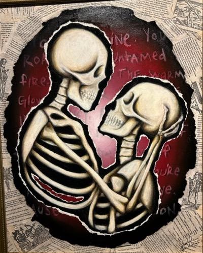 picture of two skeletons embracing with text in the background framed in newsprint