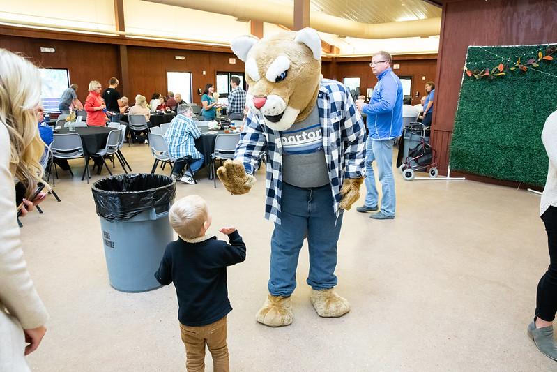 Bart high-fiving a child during the Chamber of Commerce After Hours
