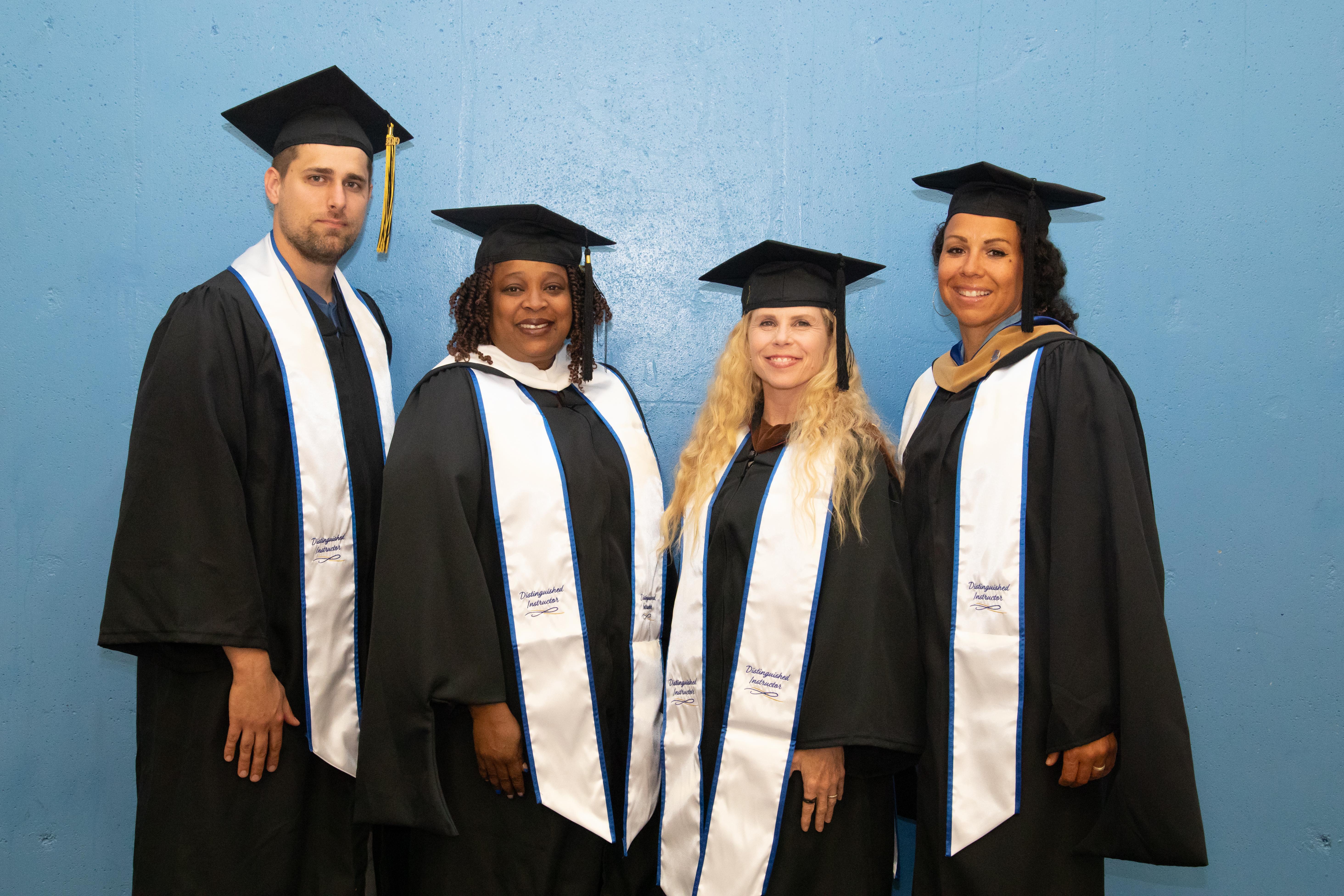 (From left) Barton 2024 Distinguished Instructors Nolan Esfeld, Ericka Peoples-Howard, Danika Bielek, and Jessica Fullen pose for a photo before the Barton commencement ceremony Friday night in the Barton Gymnasium.