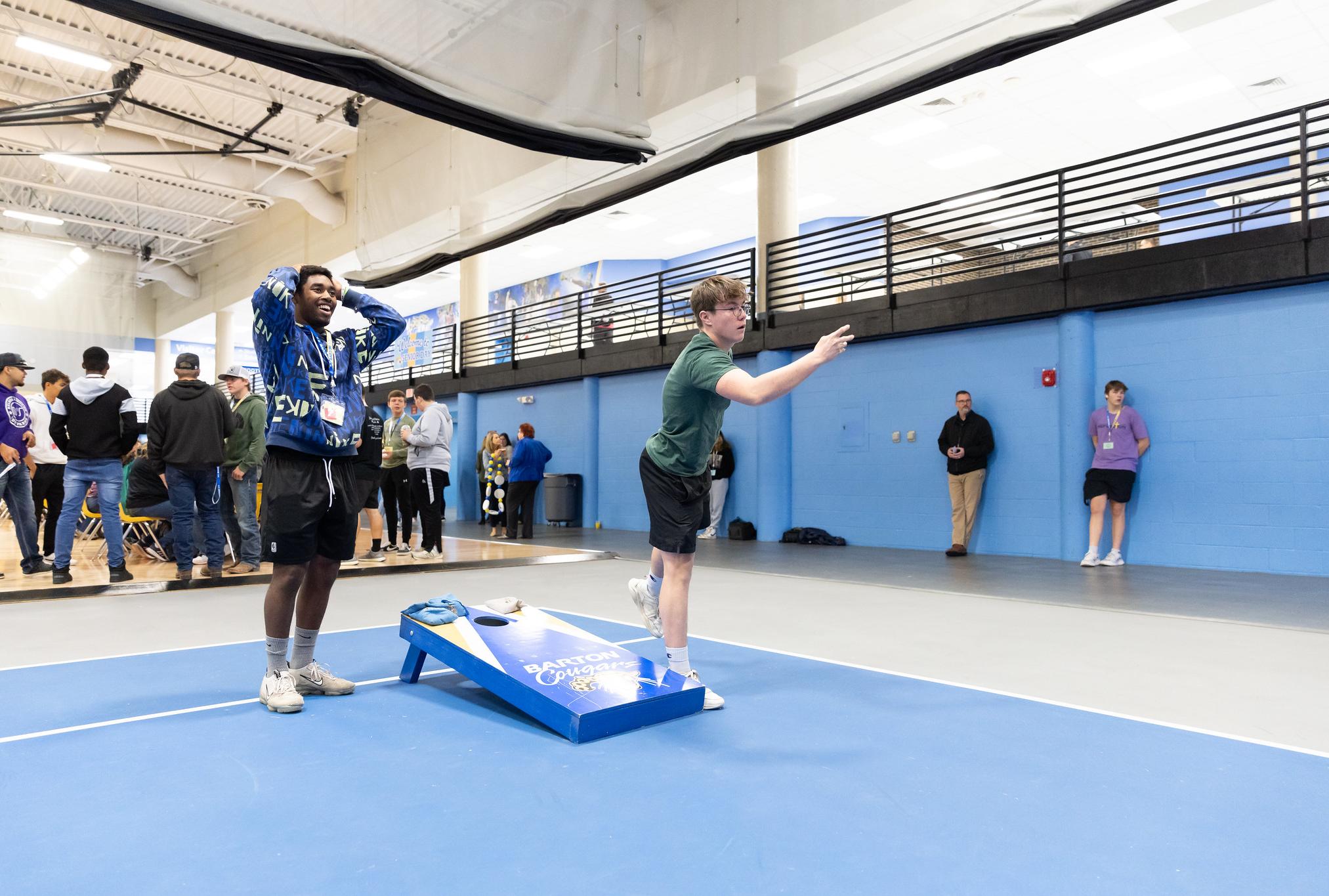 students playing cornhole