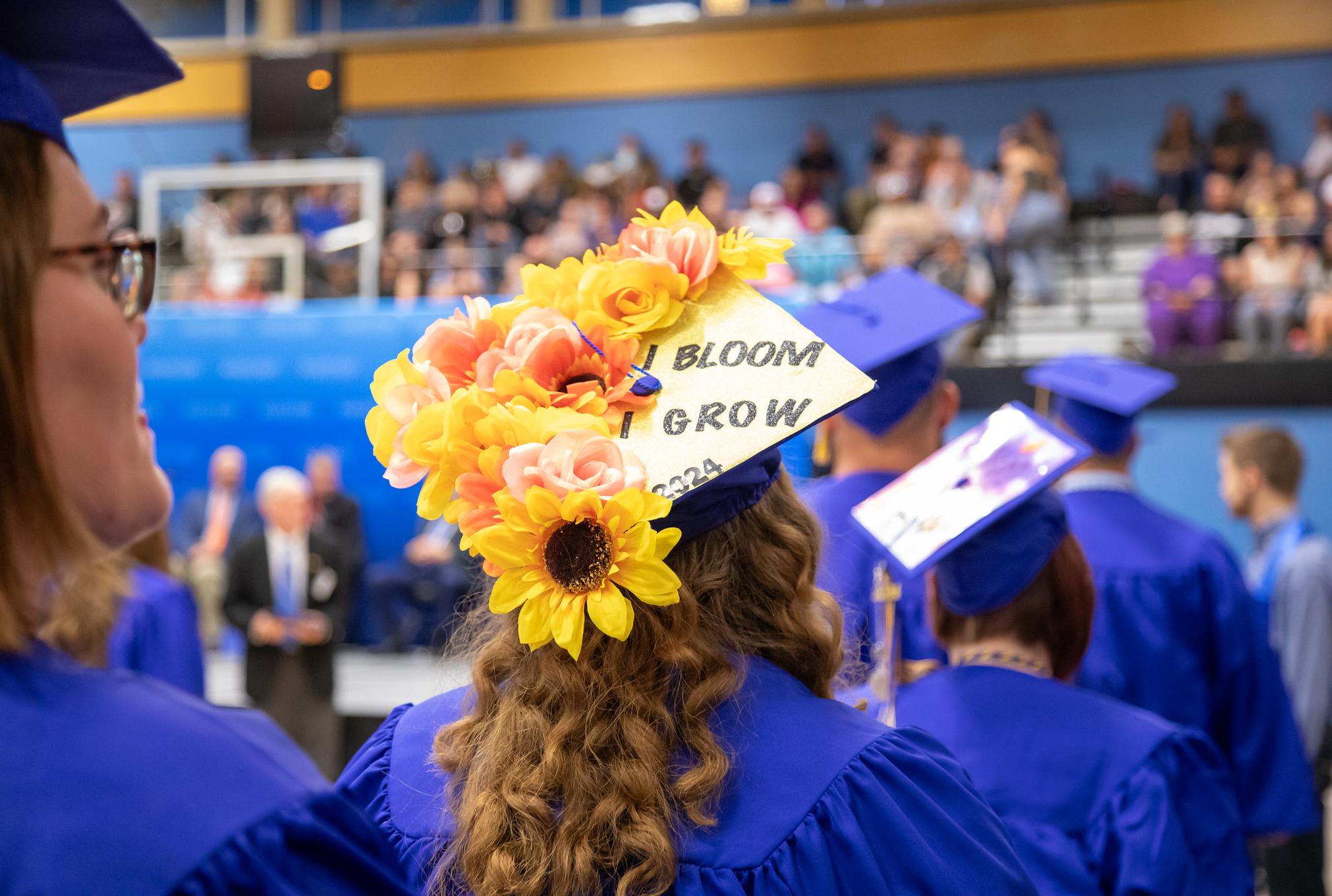 grad cap with a bunch of flowers glued to it