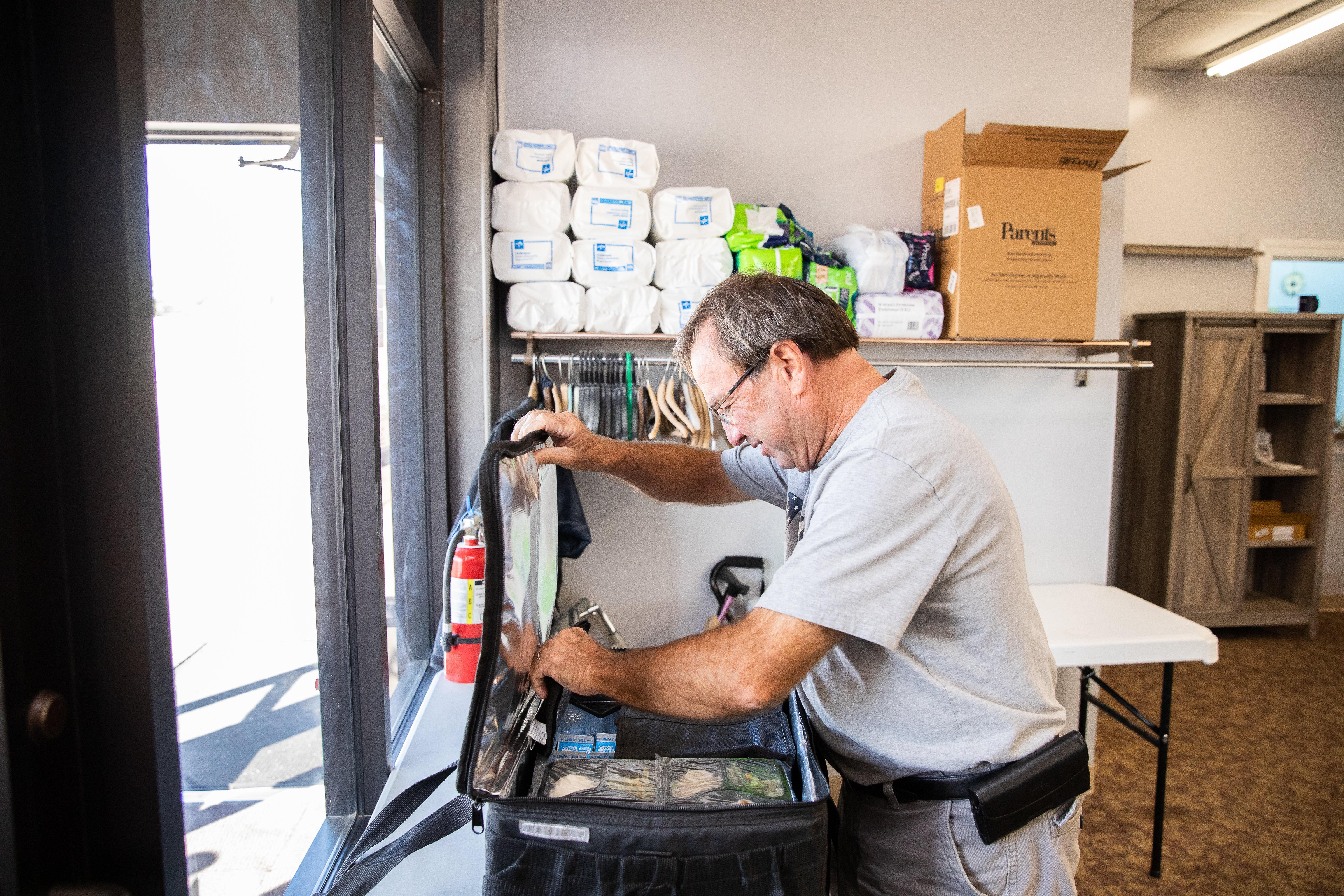 An RSVP volunteer packs meals for delivery to homebound community members through the Meals on Wheels program