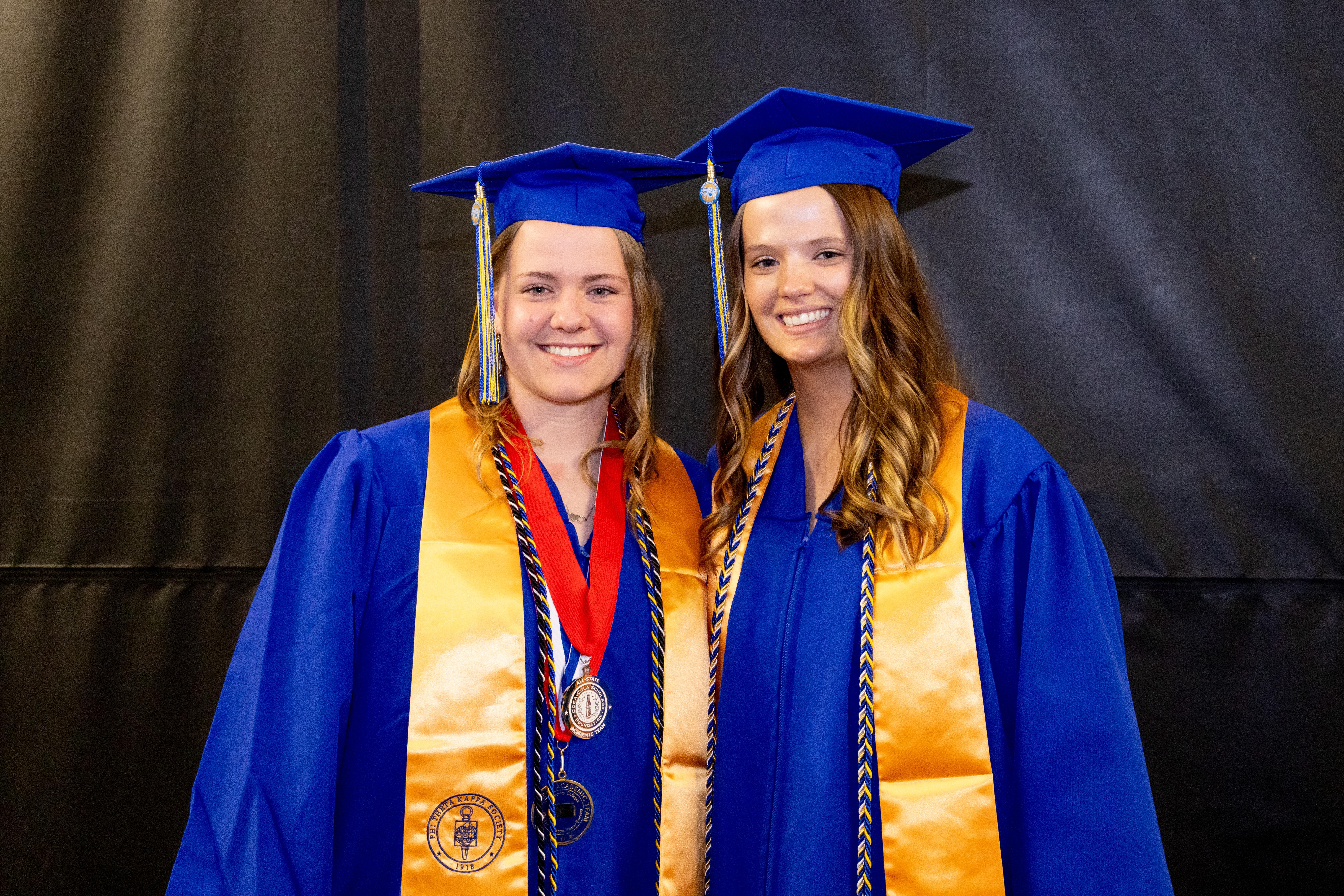 Barton 2025 Outstanding Graduates Paige Mink and Tierra Yohon pose for a photo before the Barton commencement ceremony Friday night in the Barton Gymnasium.