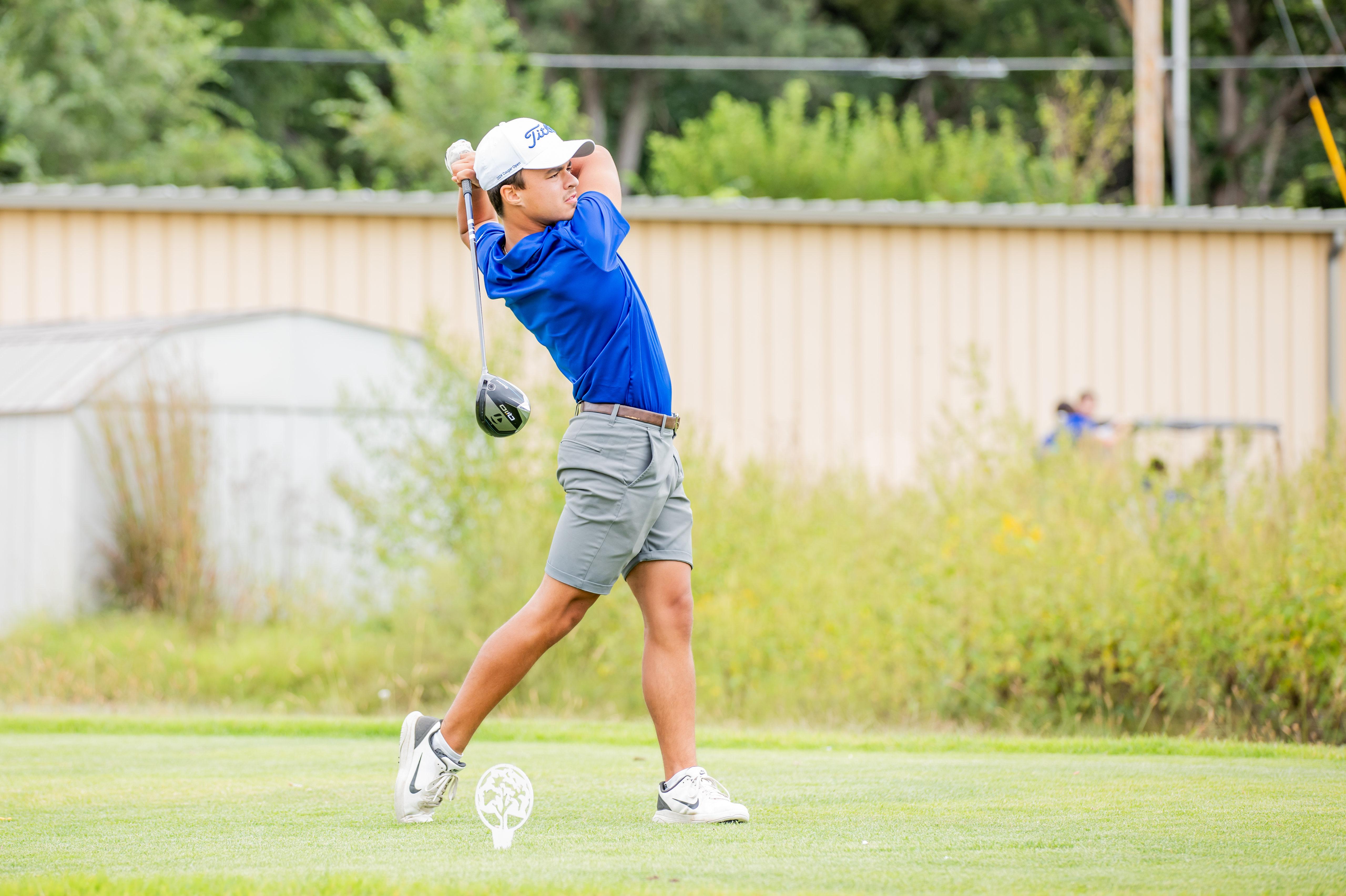 A member of the Barton men’s golf team looks on after his drive at the 2024 Wounded Warrior Golf Scramble. The scramble benefits wounded soldiers from Fort Riley.