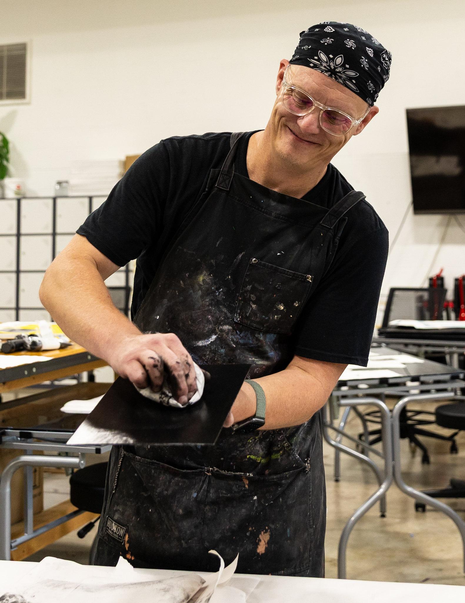 a man restoring an old printing plate from the 1800s