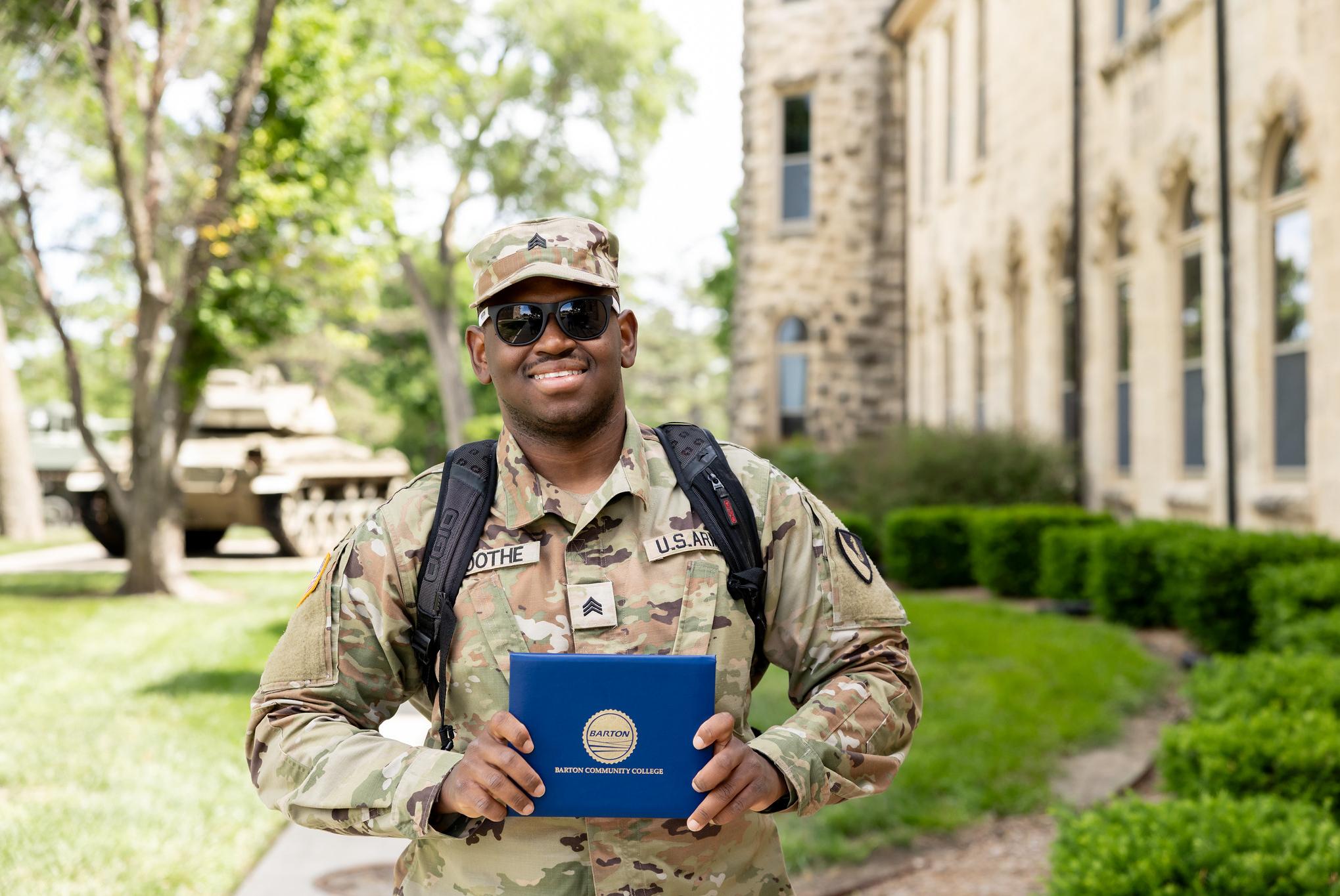 soldier holding diploma