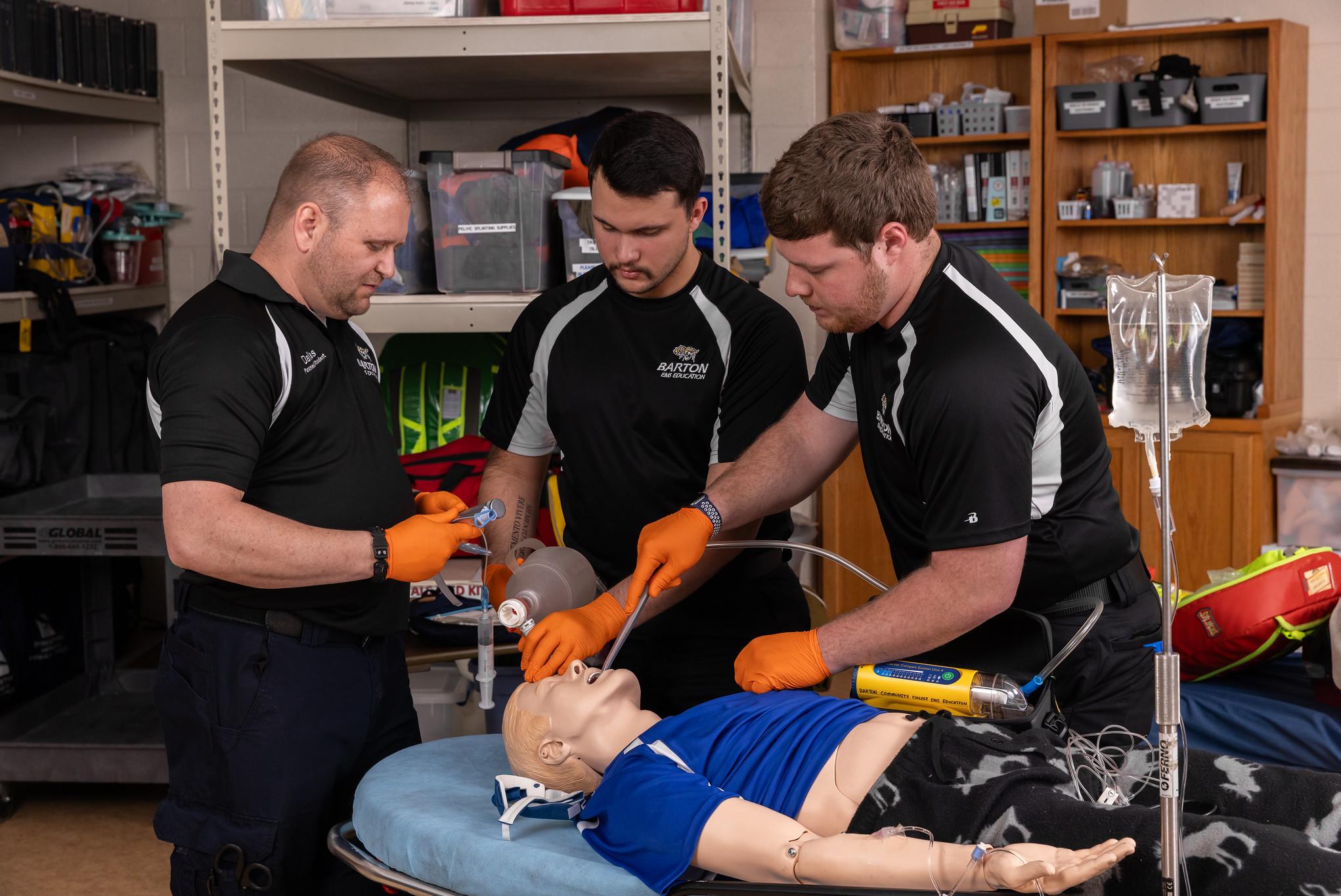 paramedics doing training on a dummy