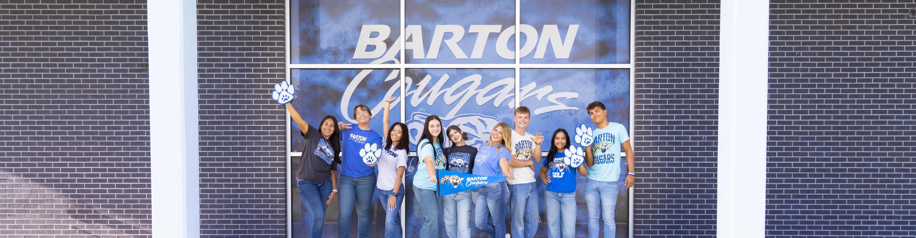 Barton student ambassadors smile and pose with props