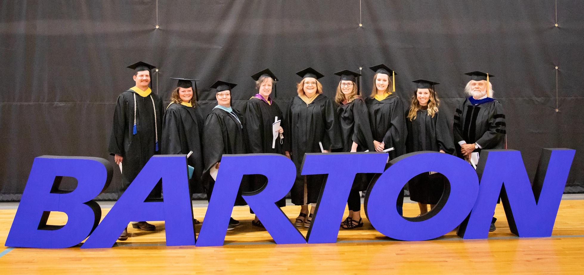 Instructors pose for a photo after commencement