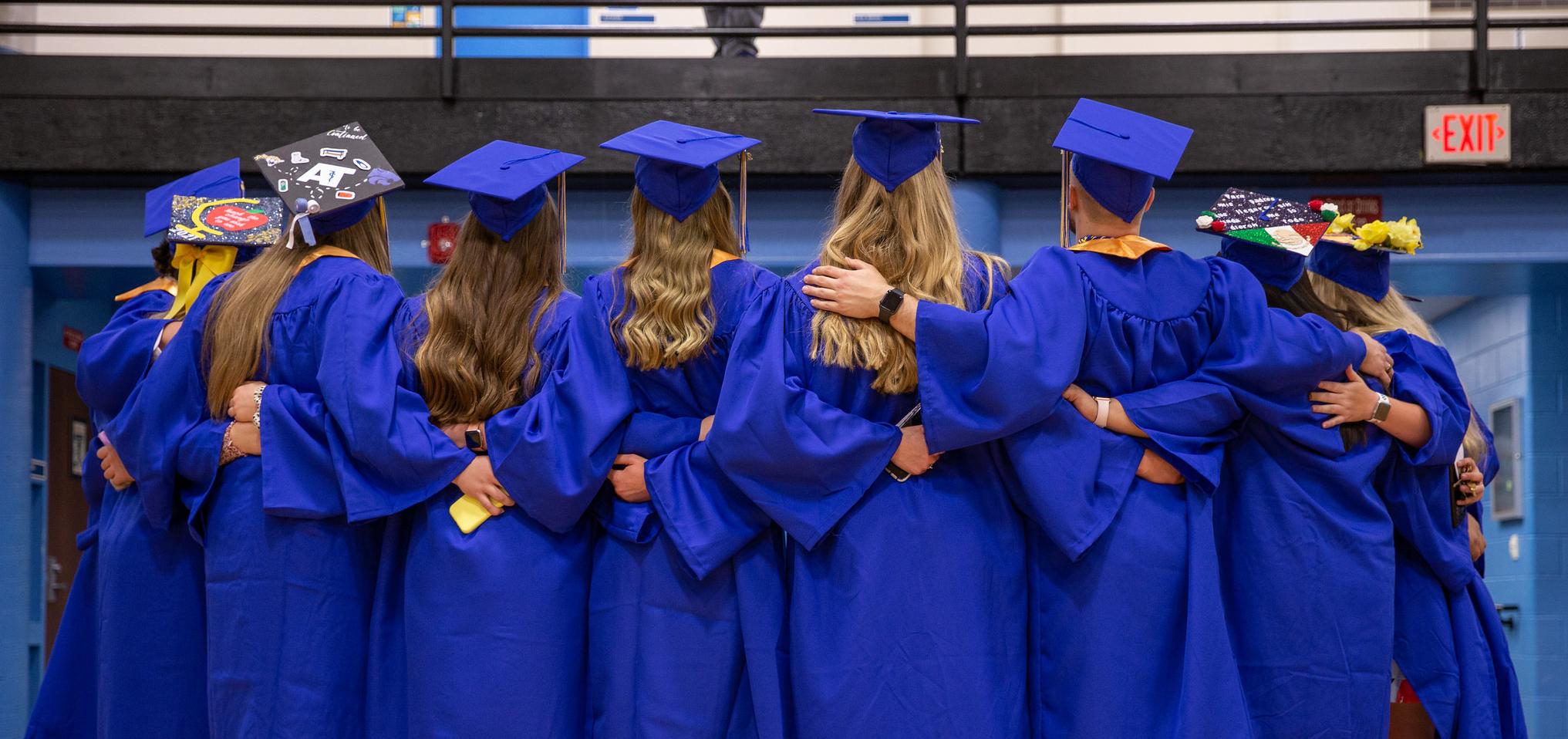 A group of graduates poses for a photo following commencement