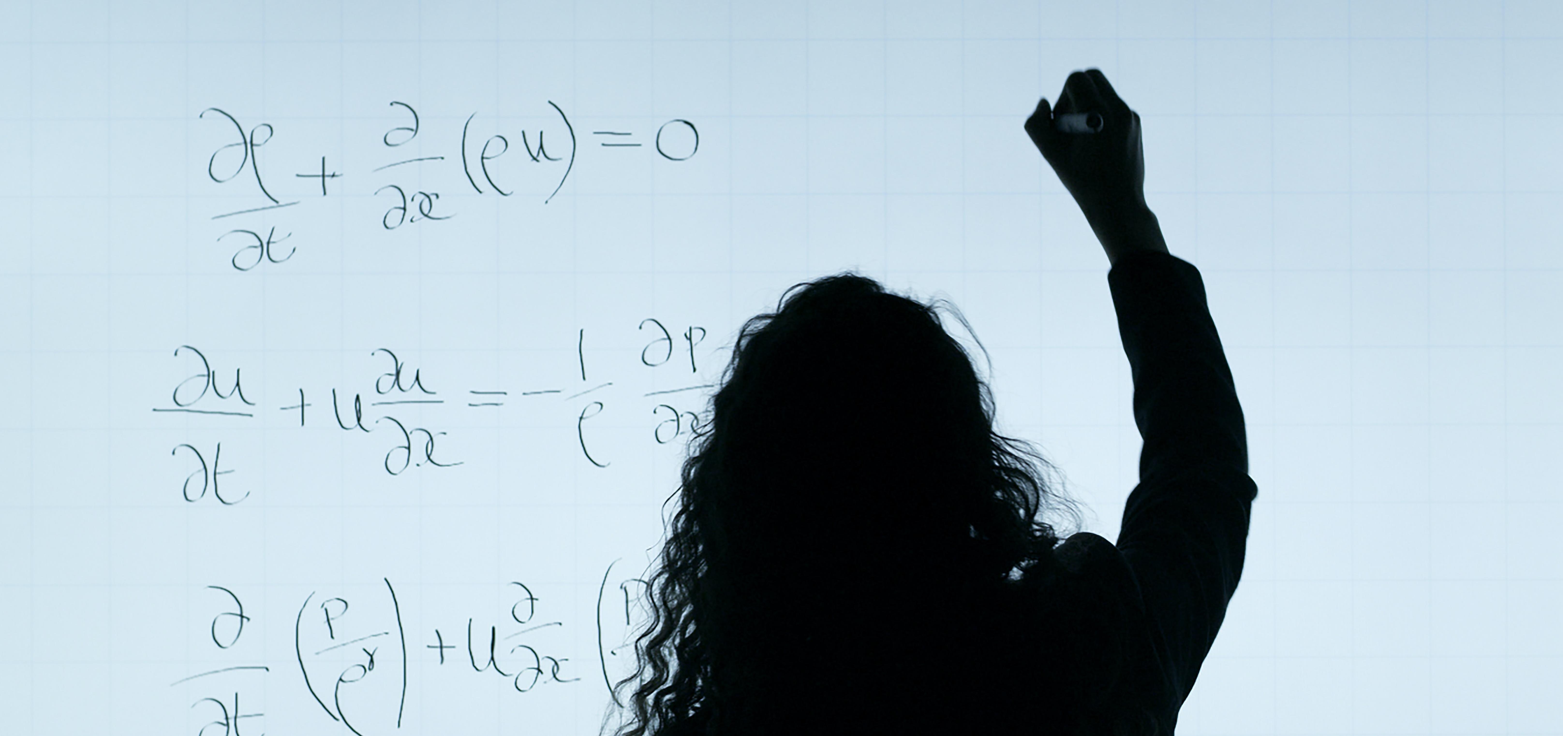 person solving math problems on white board