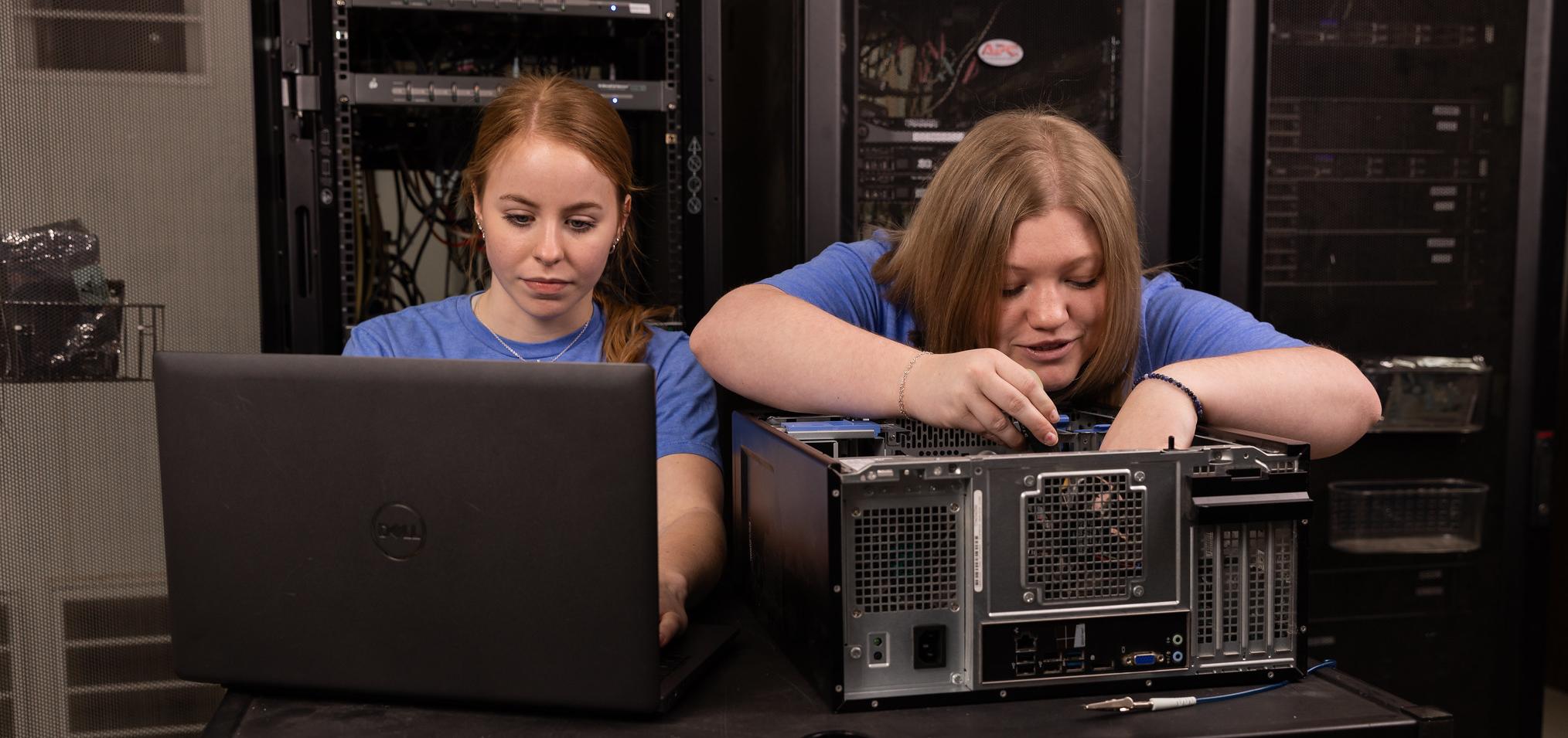 Students work on laptop and computer