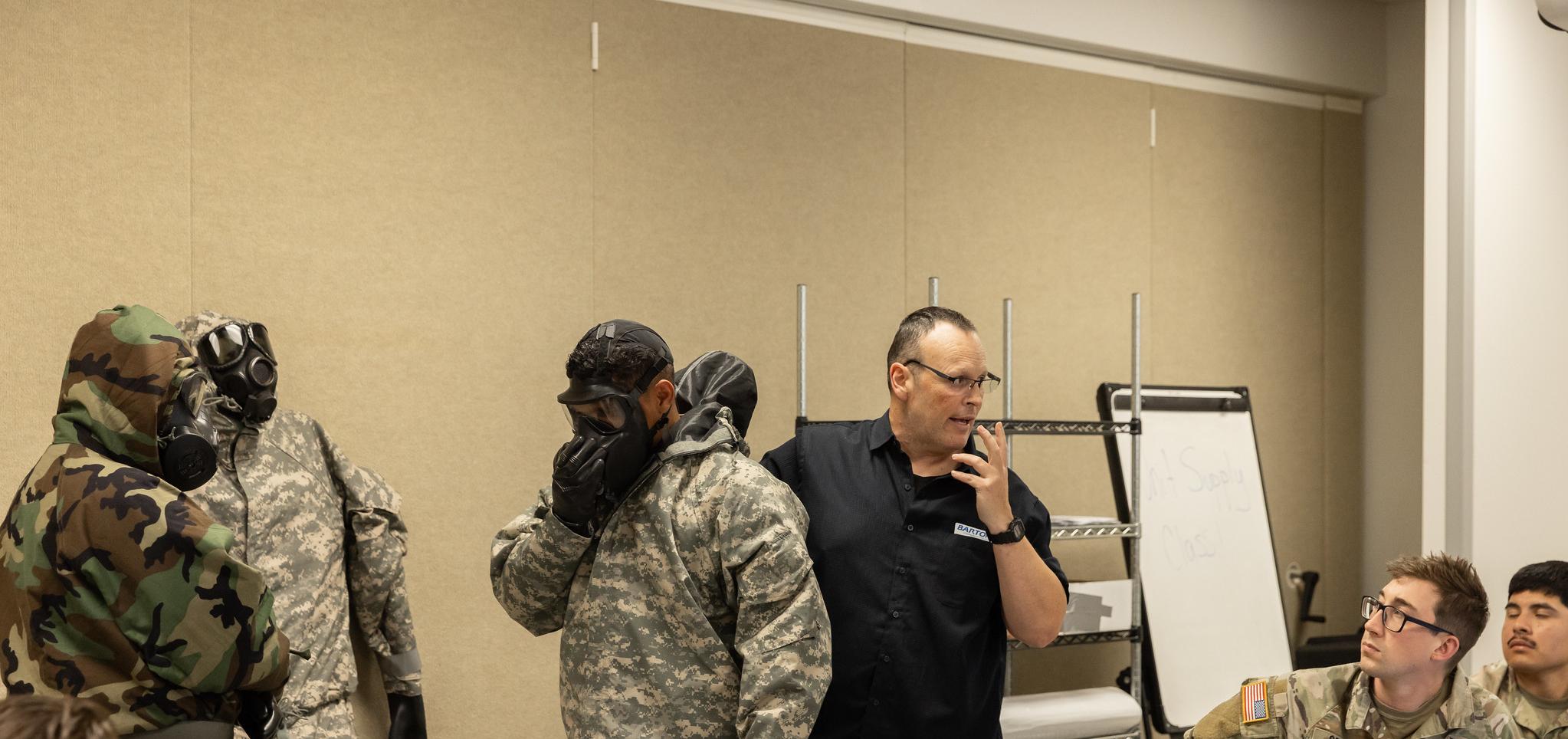 Students follow instructor demonstration in military studies classroom