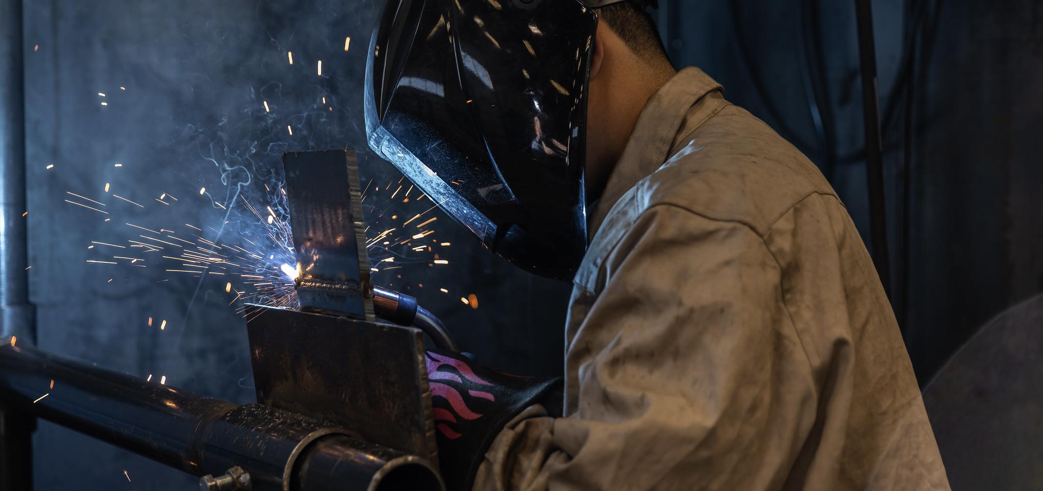Student in welding lab welds metal