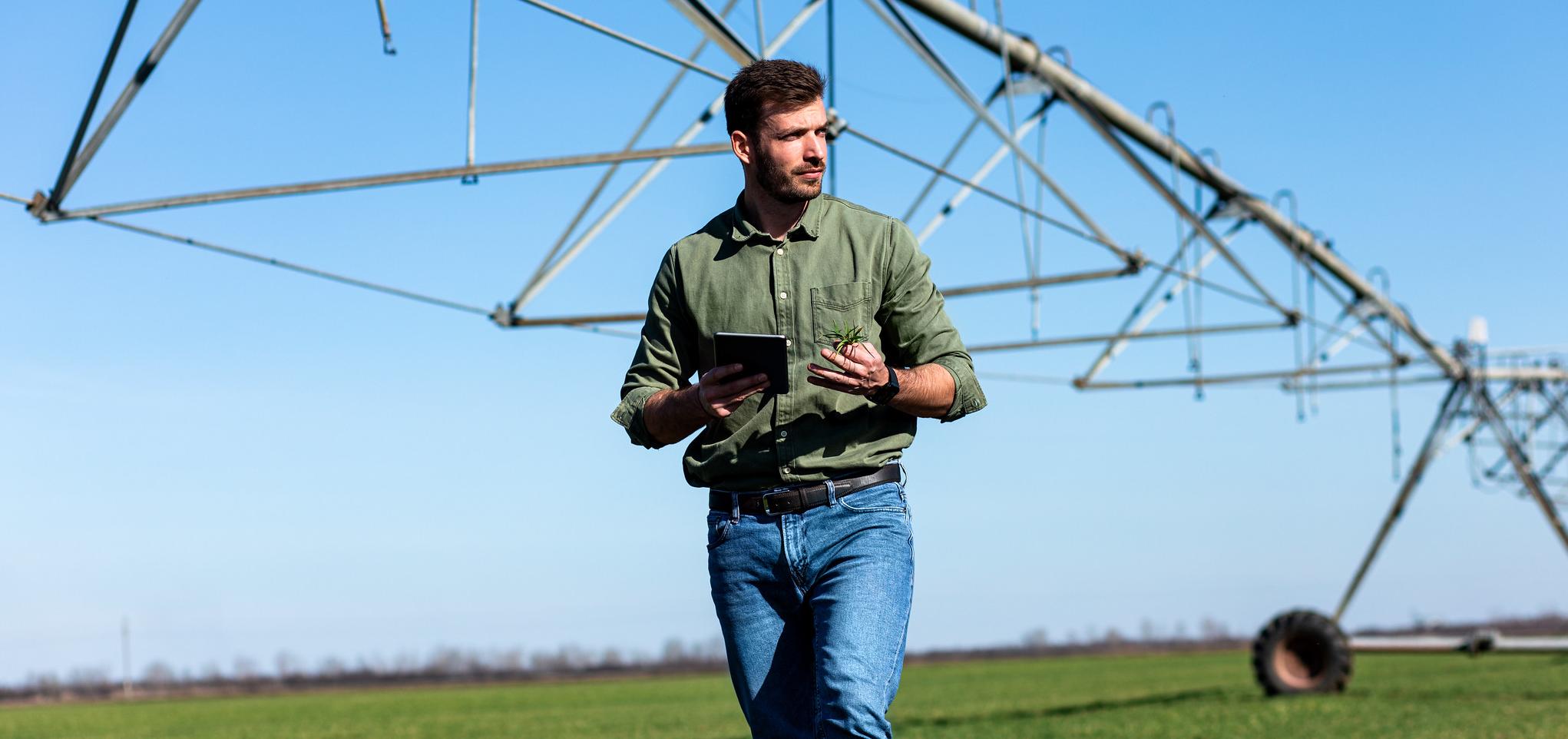 An Ag Business professional assesses field