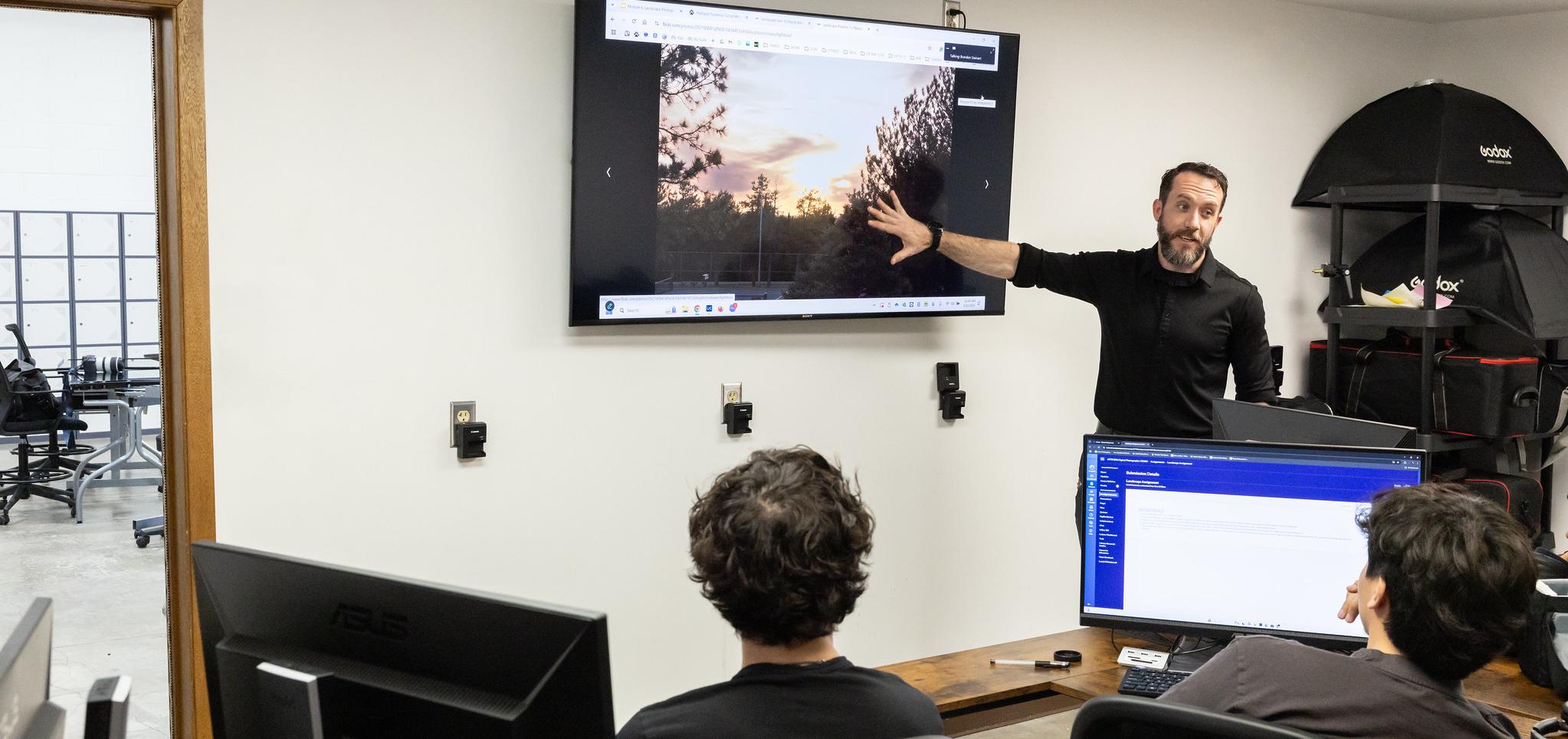 Instructor shows image in digital graphics classroom
