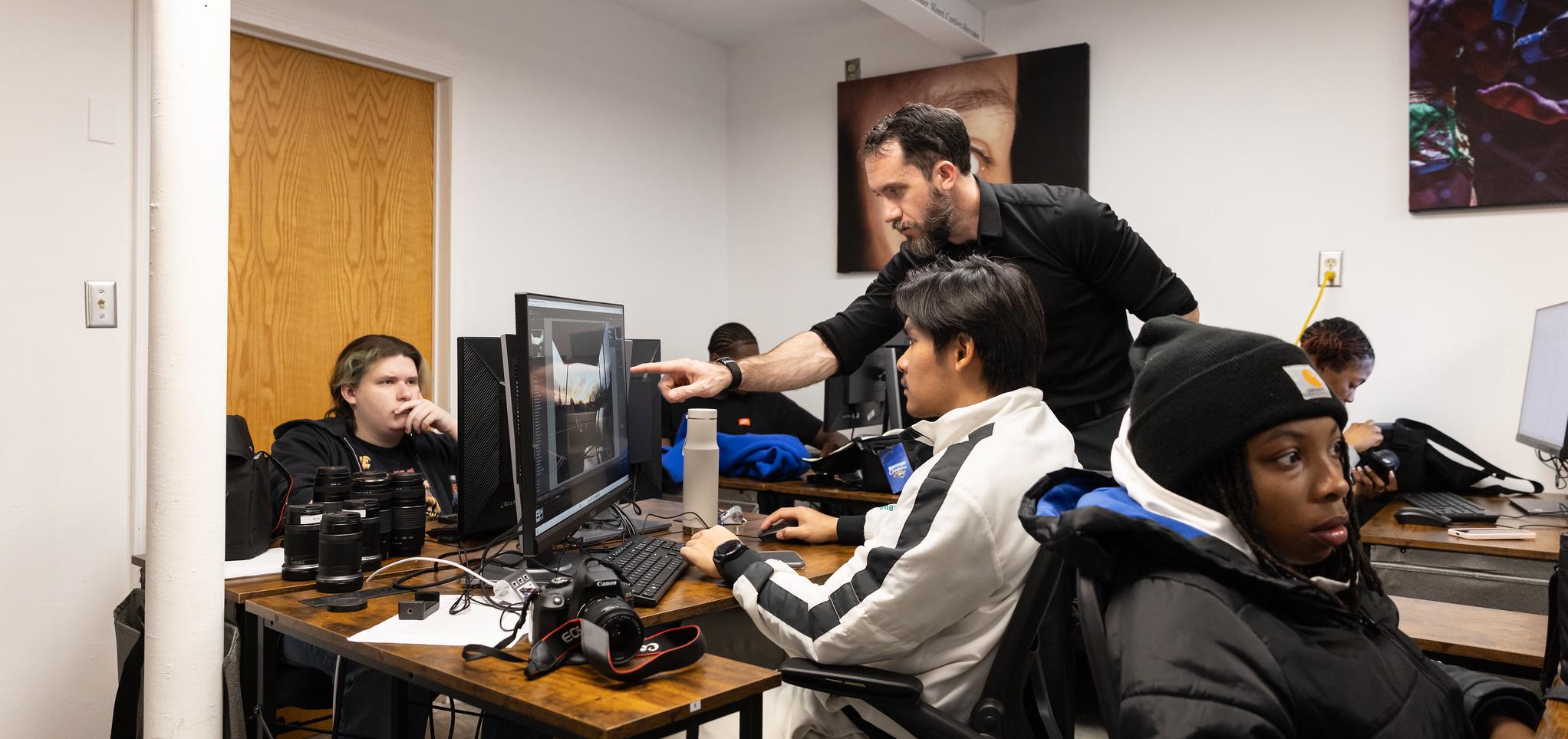 Instructor advises student on photography software