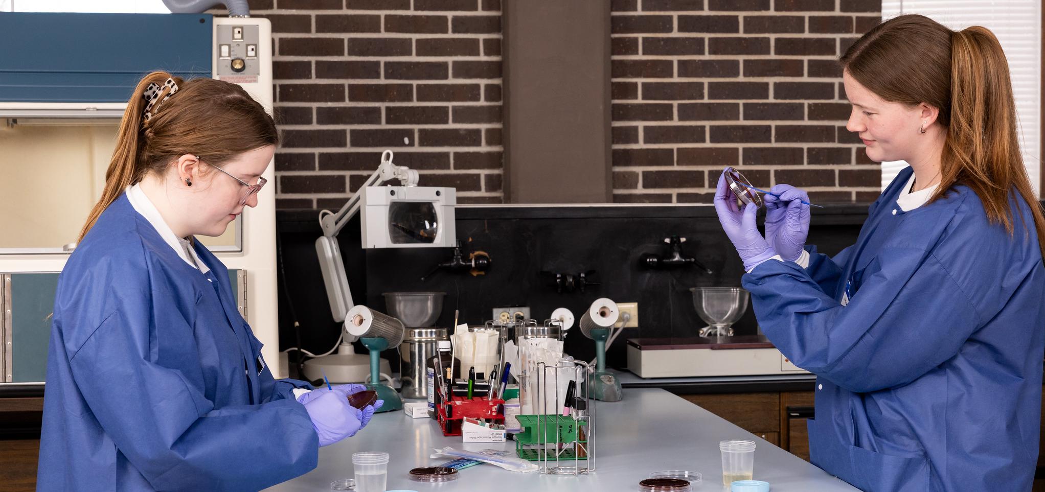 Students in medical lab text with science equipment