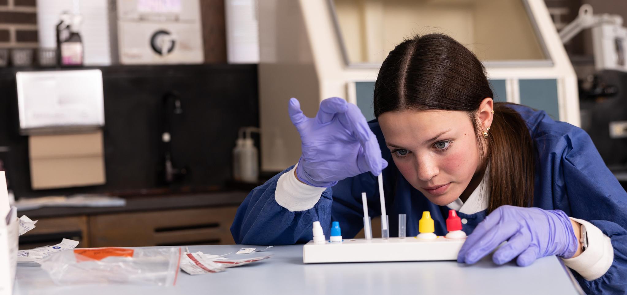 MLT student testing vials