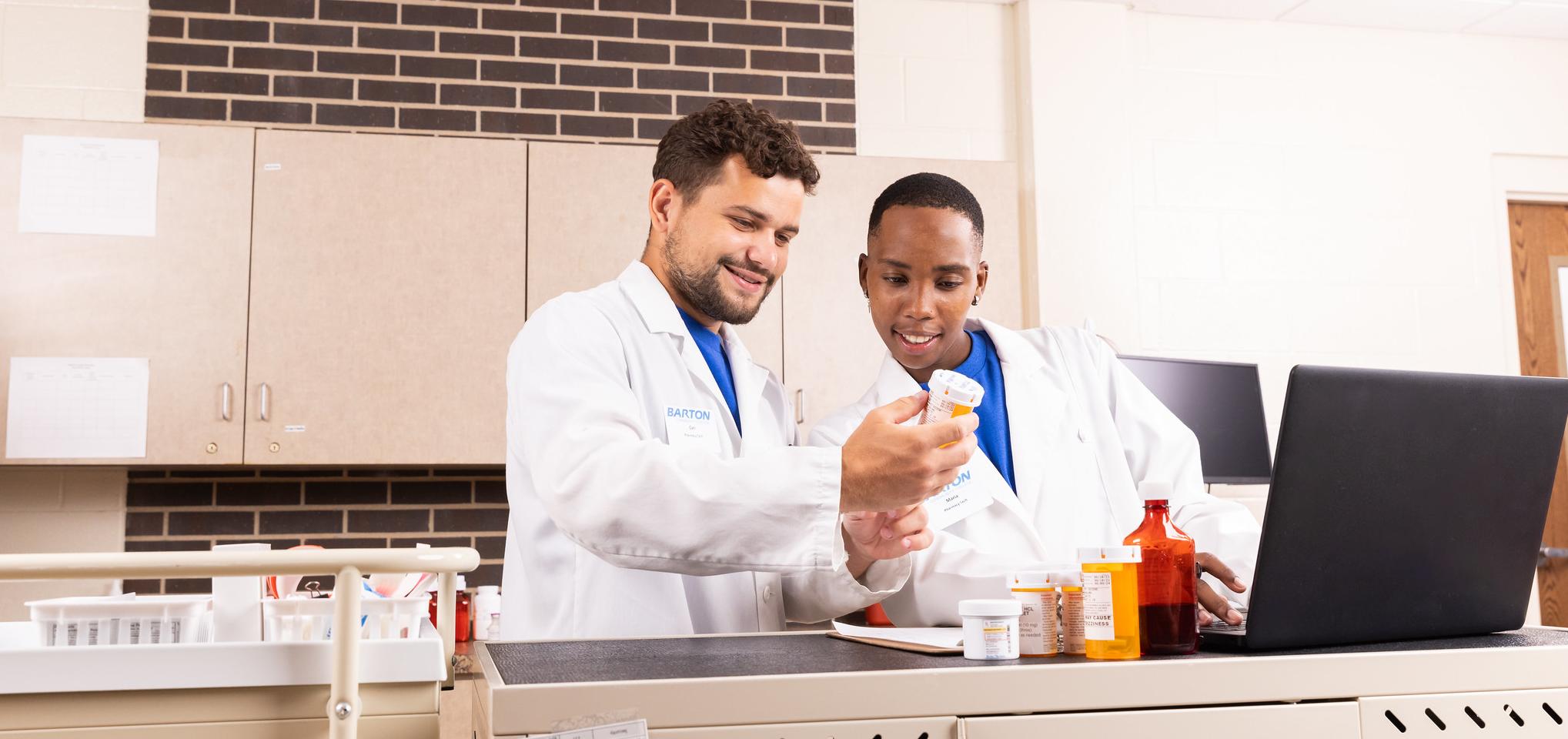 Pharmacists look at pill bottle pharmacy