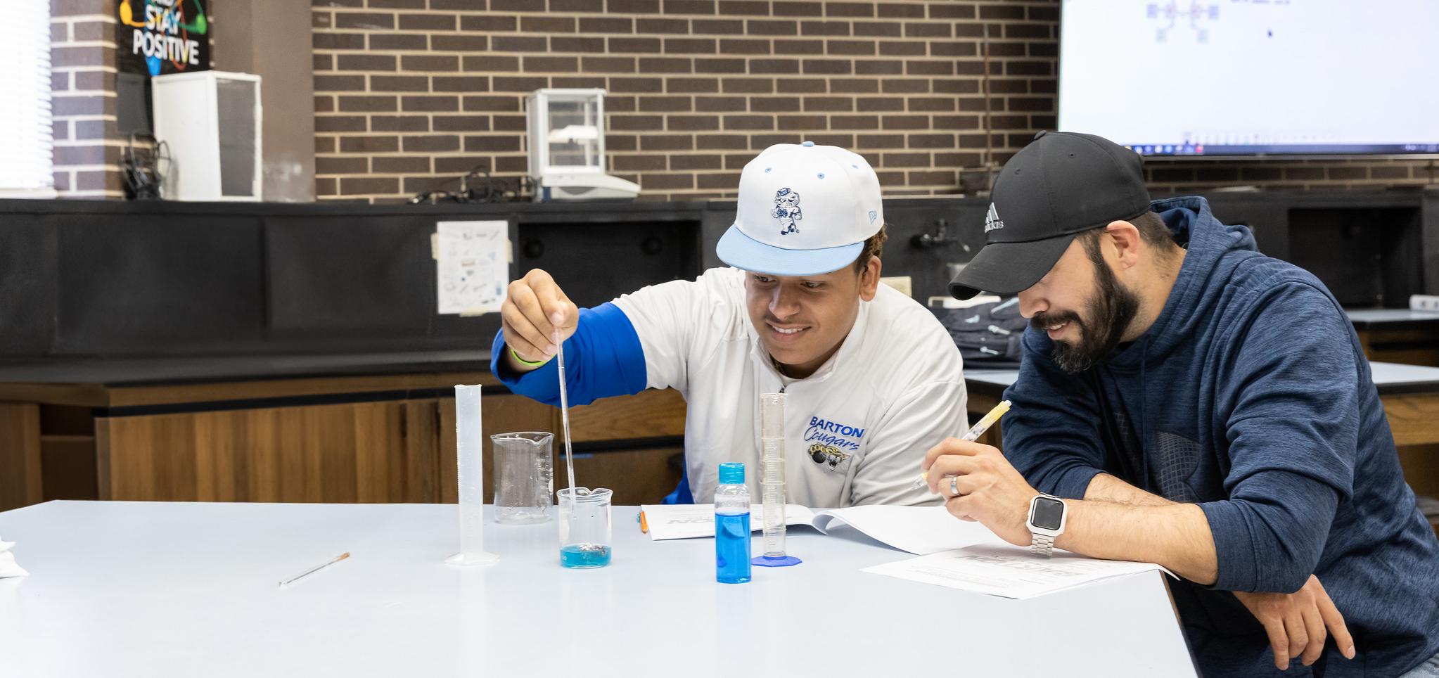 Students conduct experiment in science classroom